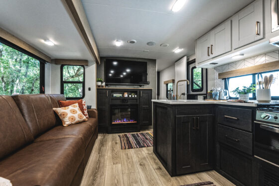 A spacious and modern living area inside a Heartland RV, featuring comfortable seating and decorative accents.