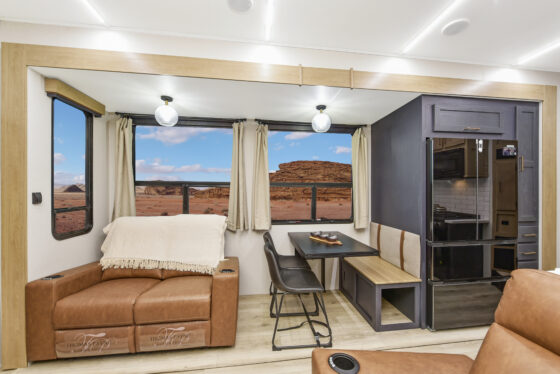 Interior of the 2025 Heartland Cyclone 4215 featuring a modern kitchen with stainless steel appliances, a spacious living area, and stylish cabinetry.