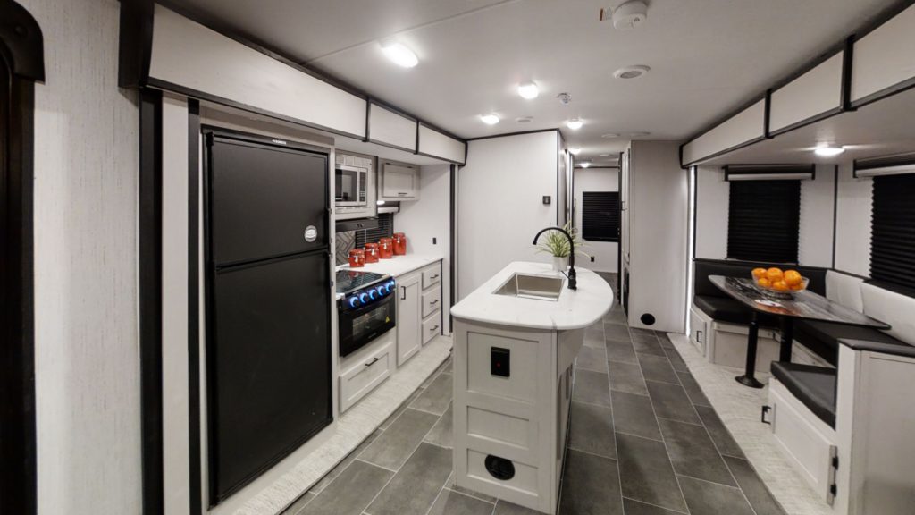 Interior view of the modern and spacious kitchen area in a Mallard M33 travel trailer by Heartland RVs.