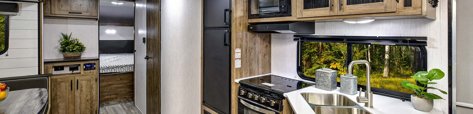 A spacious Heartland Pioneer travel trailer parked in a scenic outdoor campground.