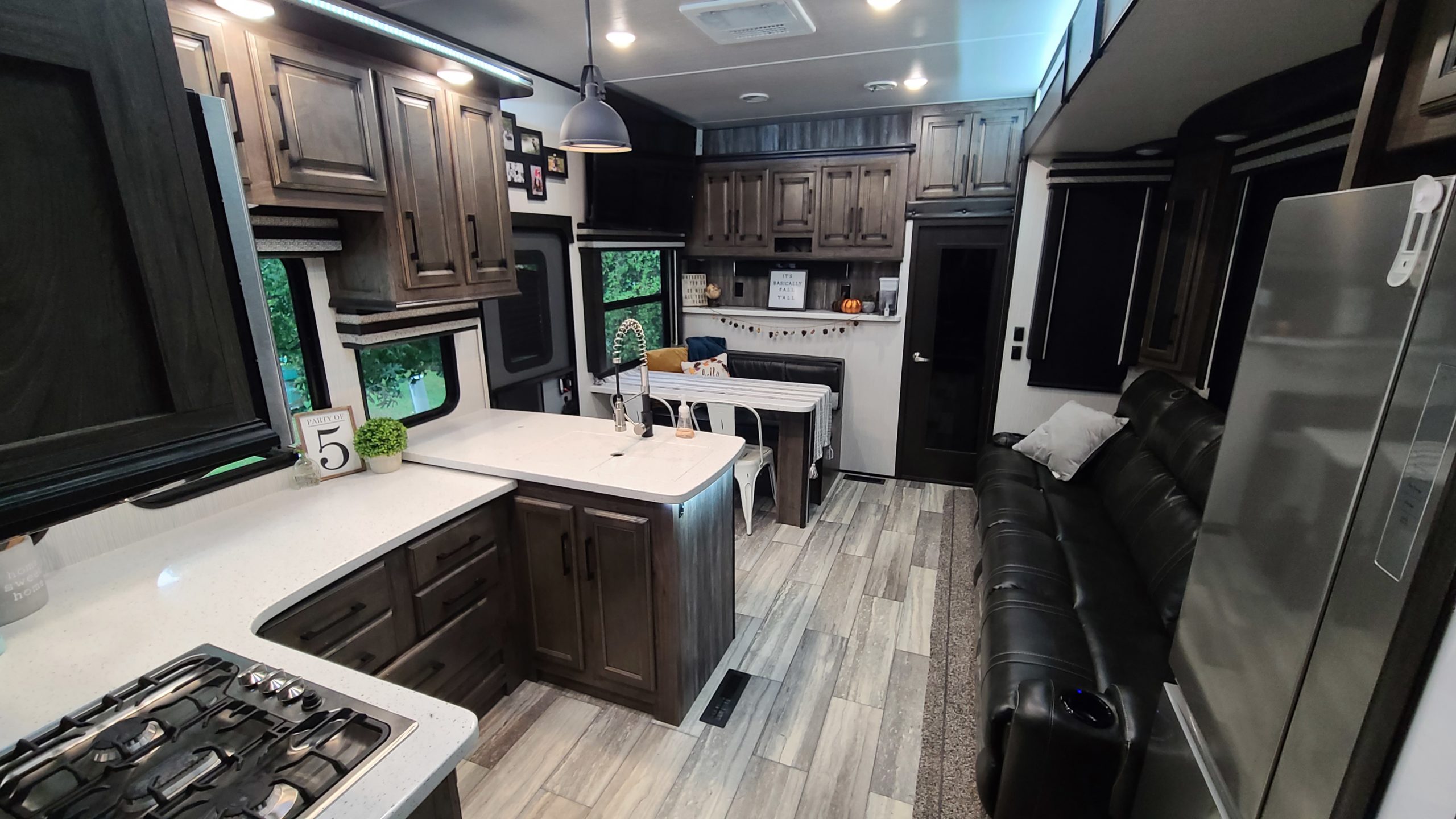 The kitchen, dining area and couch inside the Heartland Cyclone RV.