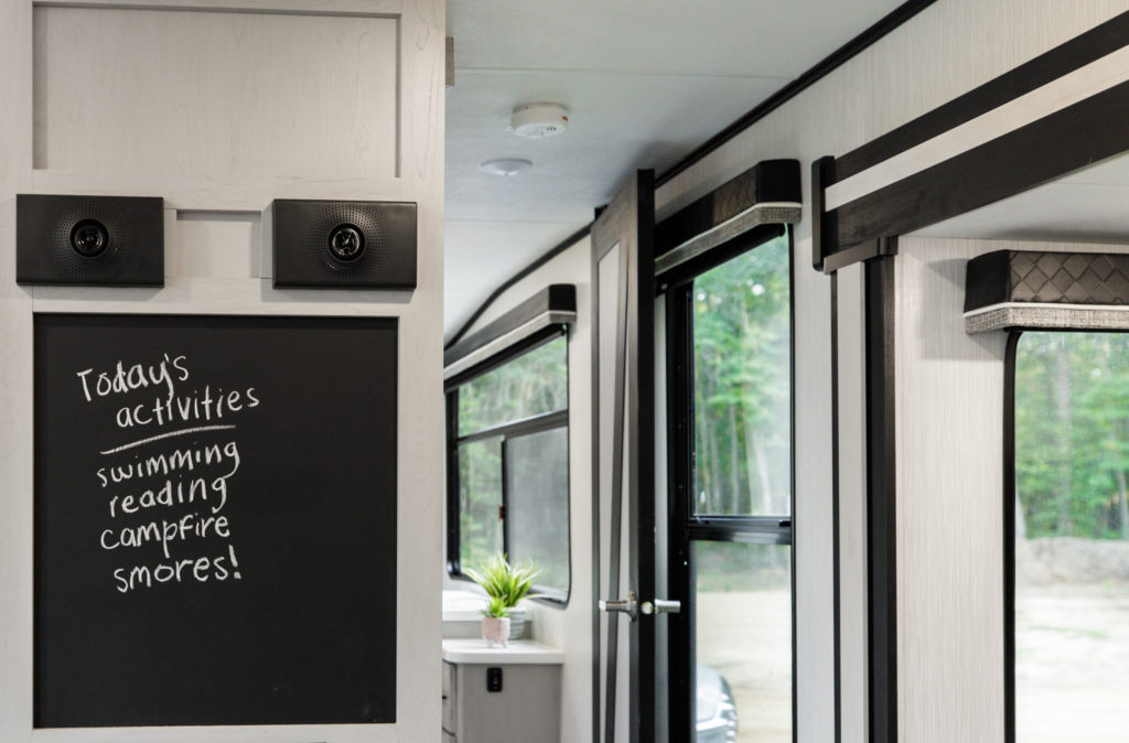 A chalkboard hanging inside an RV with a list of fun activities to do.